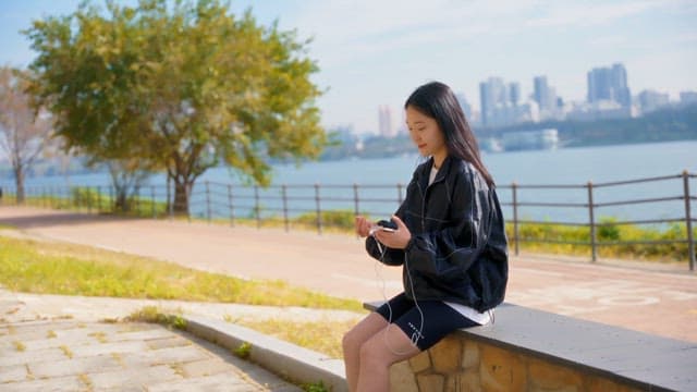 Woman enjoying music by the riverside