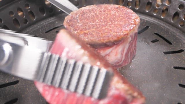 Sizzling Steak on a Grill