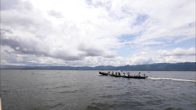 Boats Speeding Across a Scenic Inle Lake