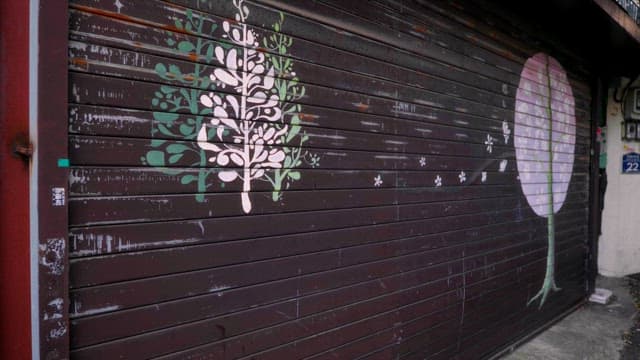 Painted trees on a closed shop shutter