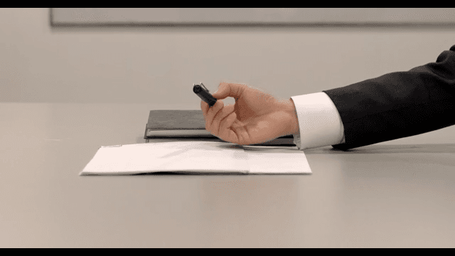 Hand Handing a Pen to Sign a Contract