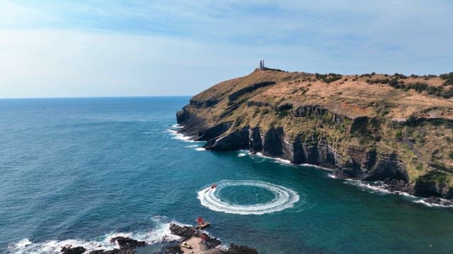 Scenic coastal cliff with a lighthouse