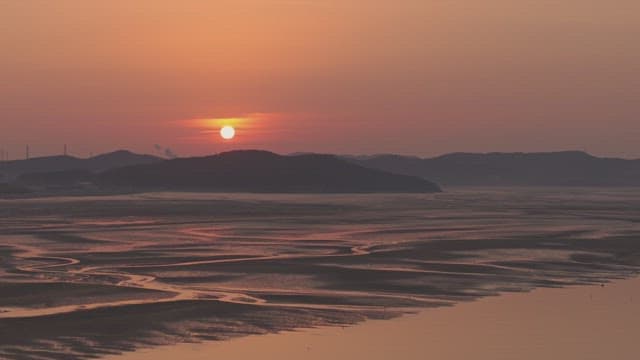 Sunset over a tranquil coastal landscape