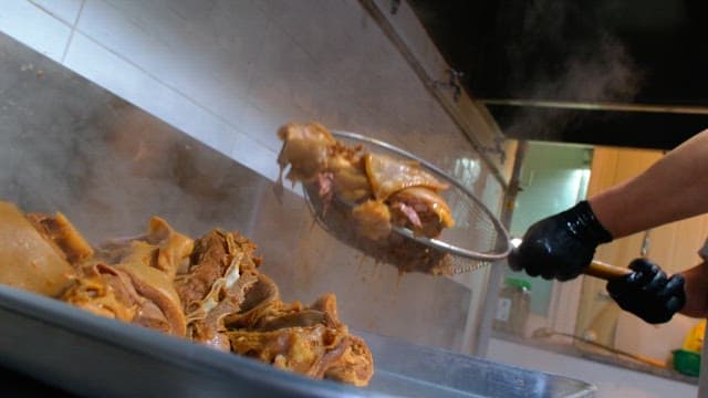 Steaming pig's feets on a metal tray