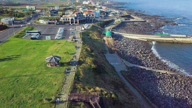 Coastal village with lush green space and parking lot