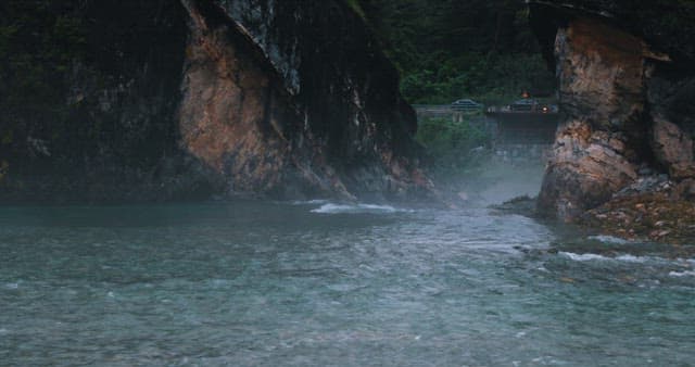 Misty River Flowing Through Rugged Cliffs