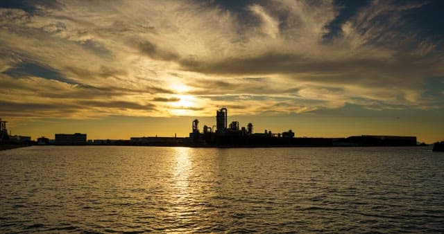 Industrial complex landscape near the sea from evening to night