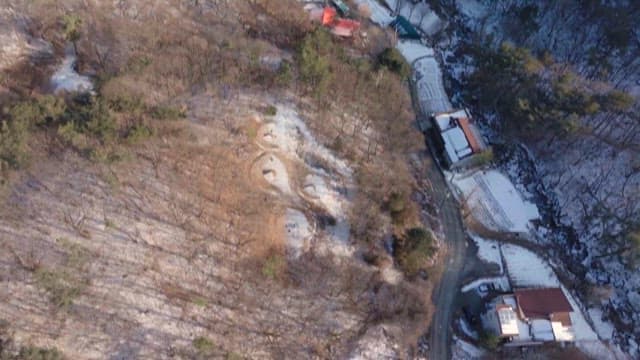 Overhead View of Snowy Village and Mountain Landscape