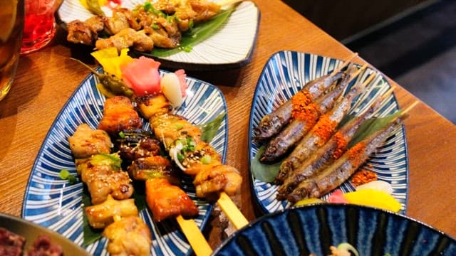 Table generously laid out with a variety of Japanese cuisine