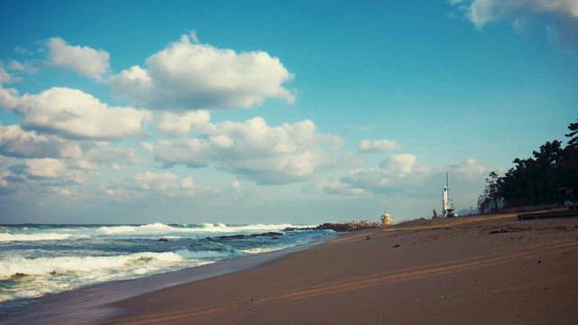 Serene Beach with Gentle Waves and Blue Skies
