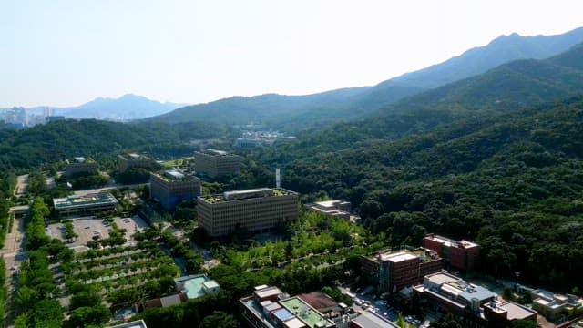 Square buildings surrounded by green mountains