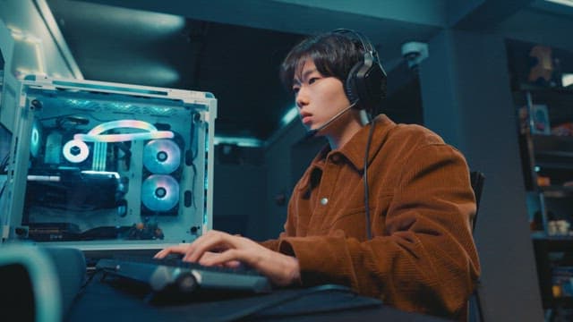 Young adult using a computer in a gaming cafe