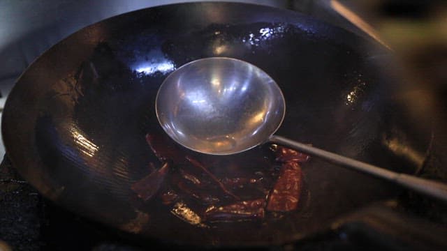 Stir-frying vegetables and shrimp in a wok