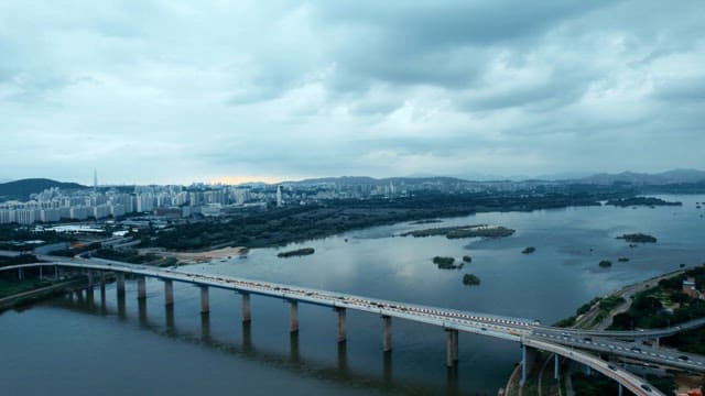 Bridge over a river with city skyline