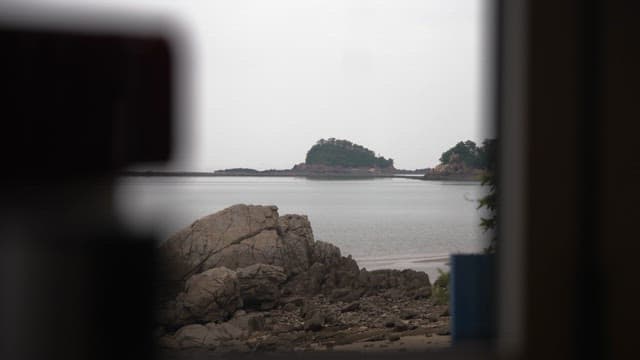 Serene Seaside View Through a Window