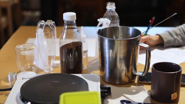 Cooking utensils and ingredients arranged on a table indoors