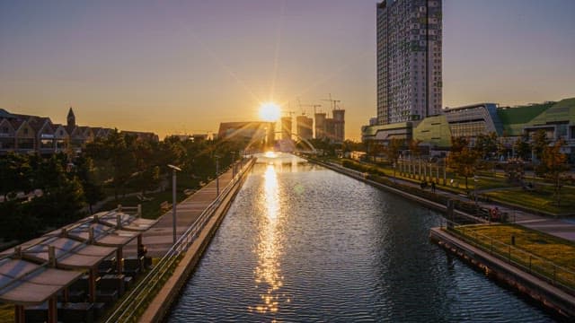 Urban Canal and Skyline with Glowing Twilight