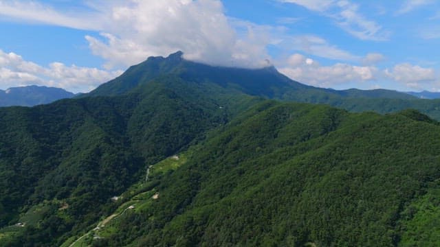 Green mountains under a blue sky