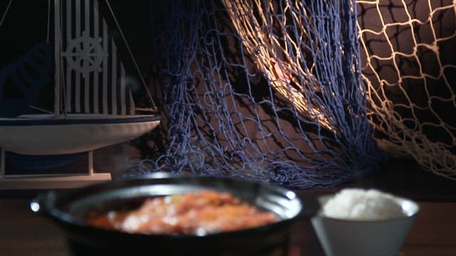 Rice and stew served on a cozy, dark table