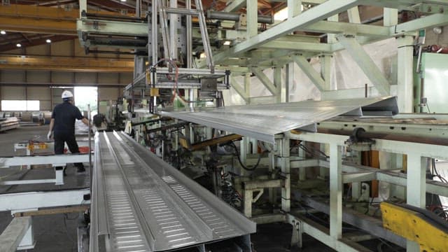 Metal sheets being processed in a factory