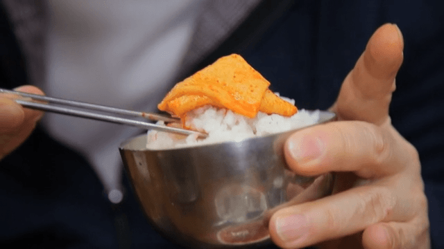 Enjoying spicy fish cake with rice