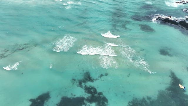 Waves gently rolling over a turquoise sea