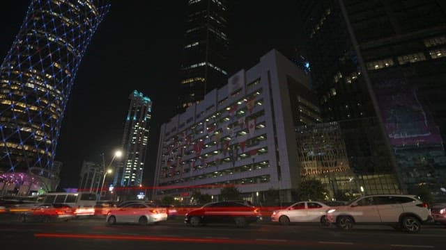 Bustling Nighttime Cityscape with Busy Traffic