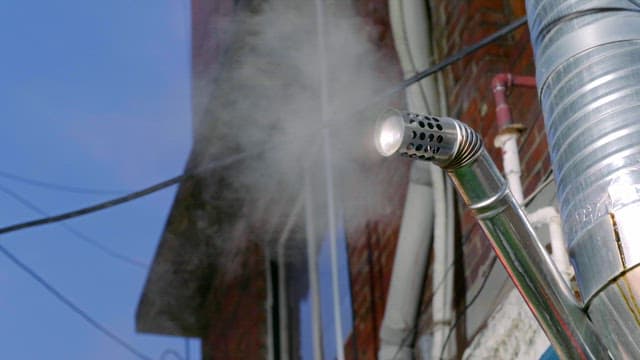 Steam emitting from a metal pipe