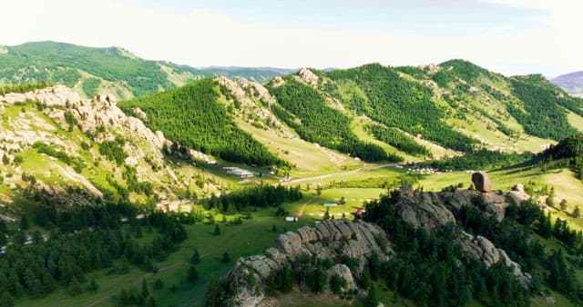 A vast green valley with rocky mountains