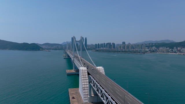 Gwangan Bridge with cars passing over the vast emerald sea