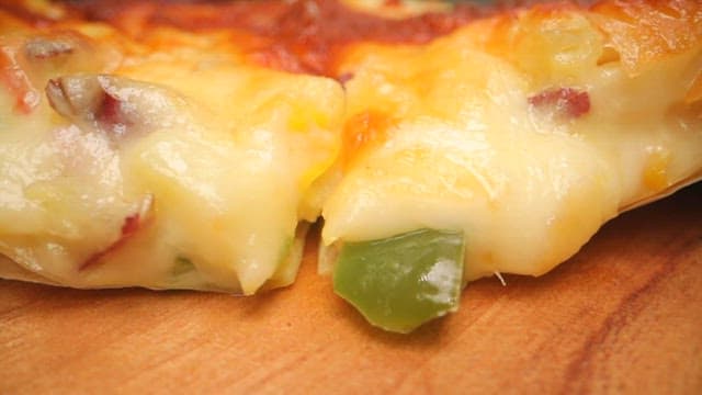Cheese pizza with toppings melting