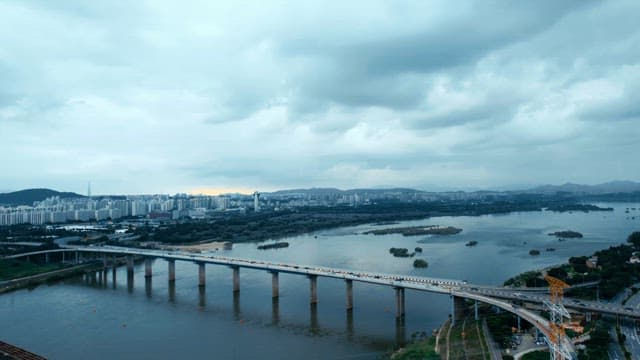 Bridge over a river with city skyline