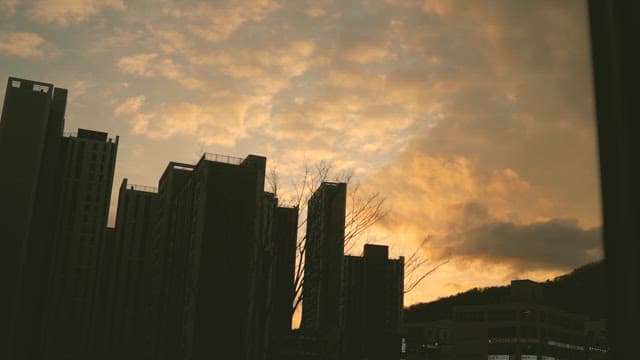 Twilight clouds passing over tall buildings