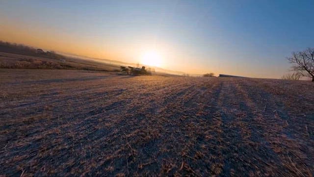 Sunrise over a tranquil farmland landscape
