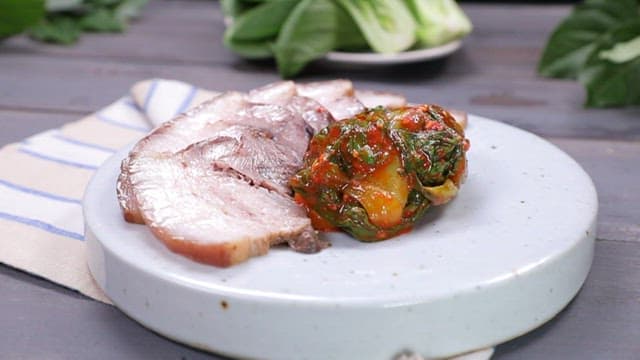 Korean boiled pork with bok choy kimchi on a plate