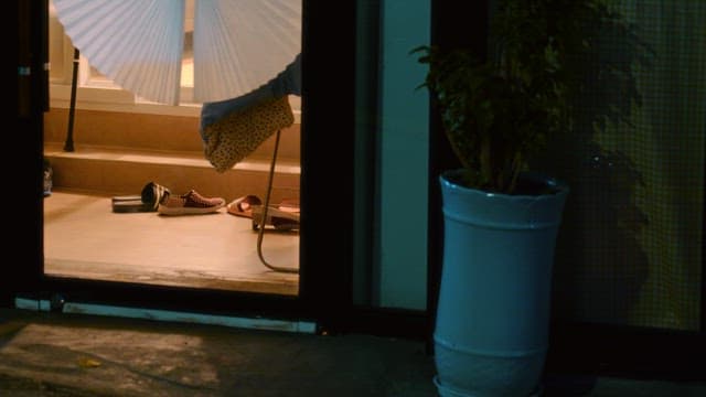 Entrance to a house at night with shoes scattered