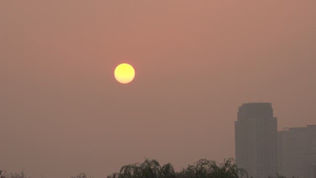 Red sky sunset with city buildings skyline