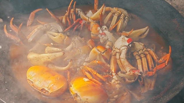 Crabs boiling in a pot with steam