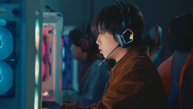 Young adult using a computer in a gaming cafe