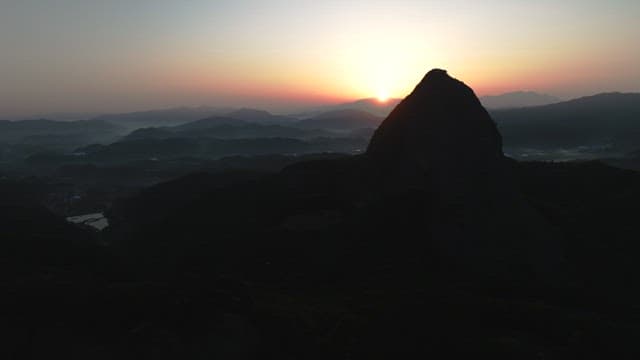 Dawning Sky and Silhouette of Majestic Mountain Peak