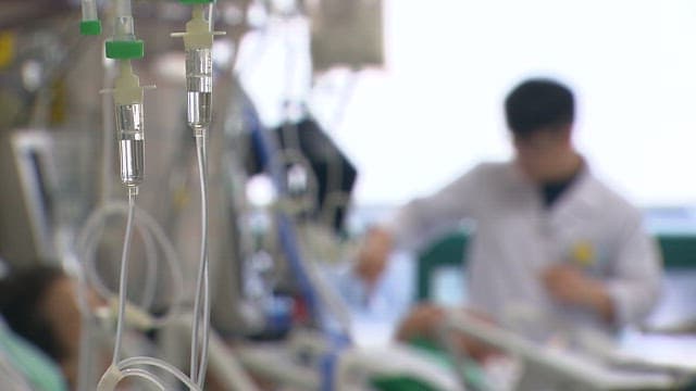 Doctor attending to a patient in a hospital room