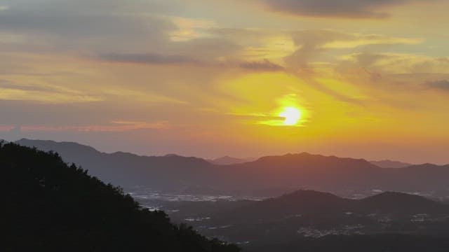 Serene Sunset Over Silhouetted Mountains