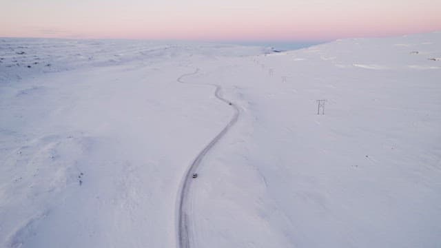Sunset snowy landscape with winding road