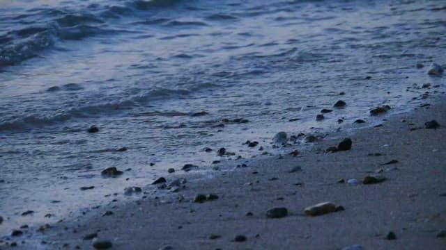 Waves Gently Washing The Pebbled Shore