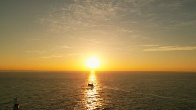 Sunset over the calm ocean horizon