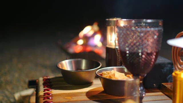 Enjoying crackers at a cozy table with candles and wine glasses