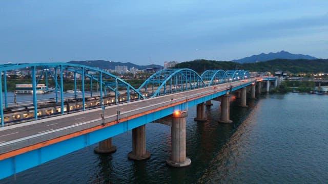 Blue bridge over a river at dusk