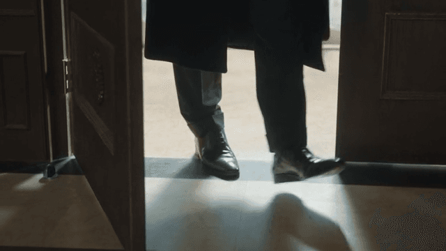 Man Entering a Room in a Suit