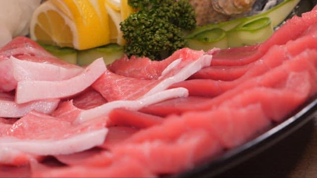 Fresh tuna sashimi slices displayed on a plate