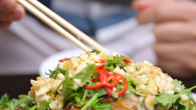 Chopstickful of five-spice pork with garlic and peppers